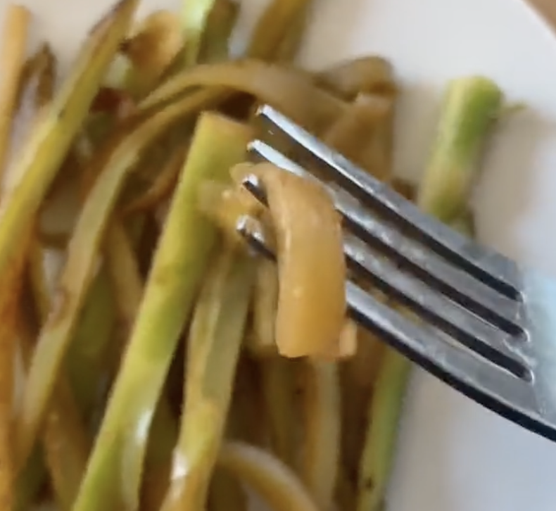 cooked broccoli stem piece on a fork